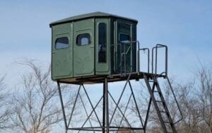 Redneck hunting blinds dark green with roomy interior and made with durable materials. Outside on hunting property.