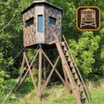 County Line wooden hunting blind with dark brown exterior in hunting property. County Line Blinds logo on top right.