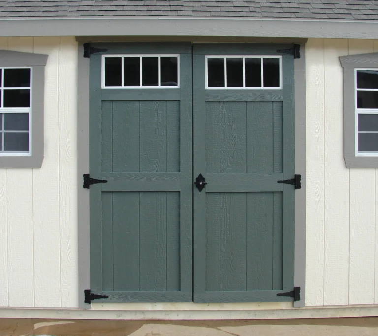Double green shed doors with transom windows.